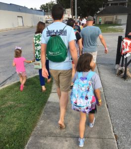AquaPhoenix employee and his daughter walking in the Walk A Mile In Her Shoes event at AquaPhoenix