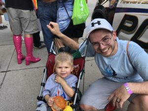 AquaPhoenix employee and child in a stroller at the 2018 Walk A Mile In Her Shoes event